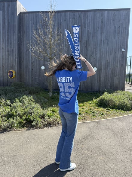 An image of a girl wearing a Varsity top.