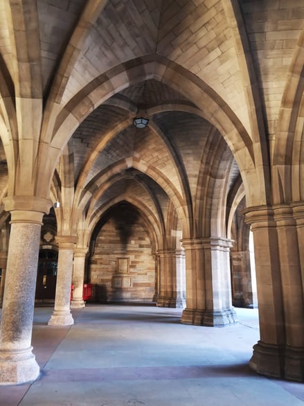 Stone cloisters archway at the University of Glasgow with vaulted ceilings