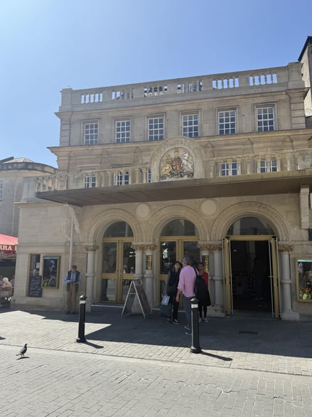 Front entrance of Theatre Royal Bath with people standing outside