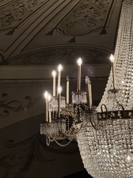 Close-up of chandelier with candle-style lights and crystal details