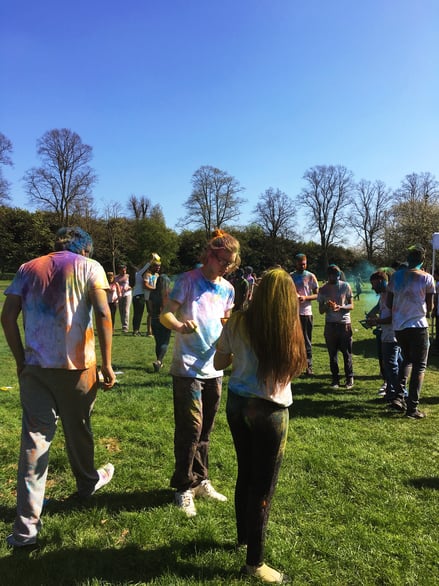 Students participating in outdoor colour festival event