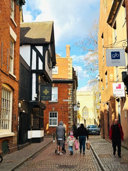 Historic street with traditional buildings and pedestrians