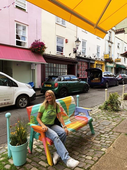 Scene of pastel houses and colourful bench in Clifton village street