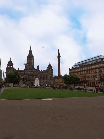 View of George Square with historic buildings and monuments in Glasgow