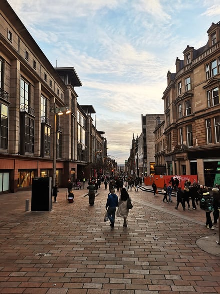 View down a busy shopping street with pedestrians in Glasgow city centre