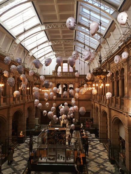Interior of Kelvingrove Art Gallery with suspended sculptures and exhibits