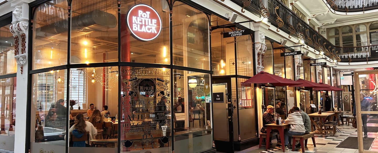 The outside of a cafe named 'Pot Kettle Black'