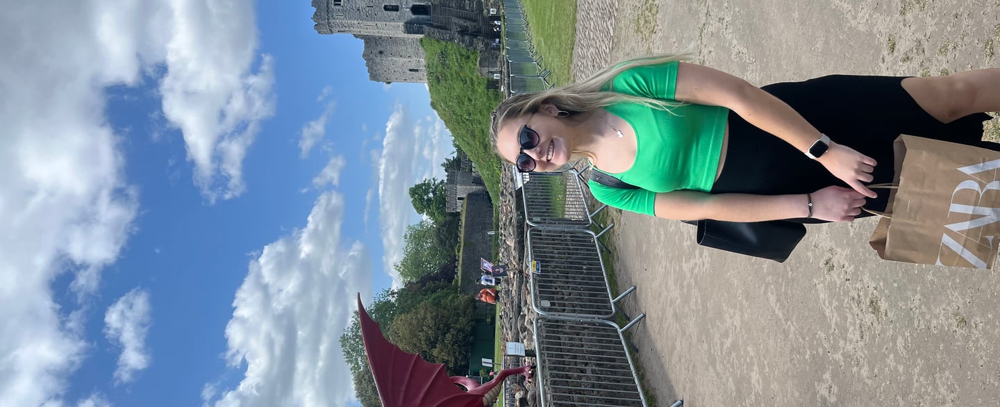 Red dragon statue near Cardiff Castle with person nearby