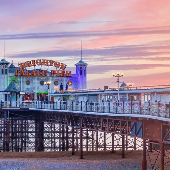 Student with phone in front of Brighton landmarks