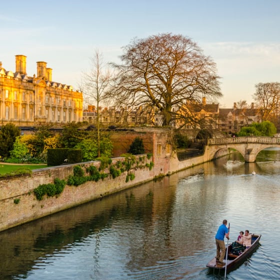 Student with phone in front of Cambridge landmarks