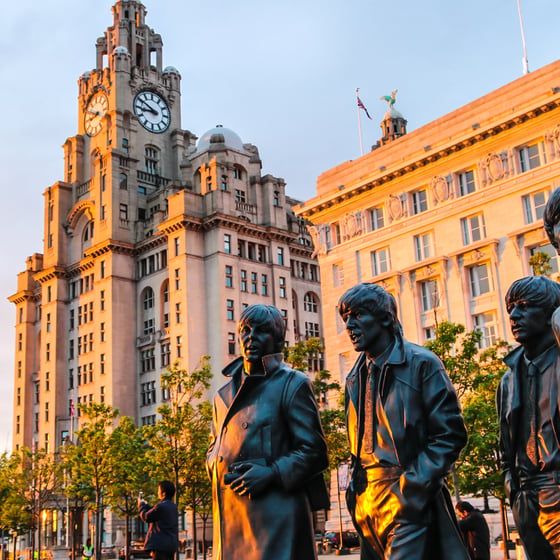 Student with phone in front of Liverpool landmarks