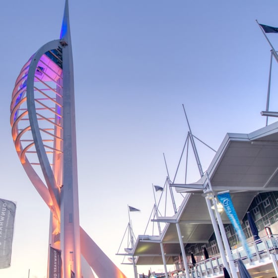 Student with phone in front of Portsmouth landmarks