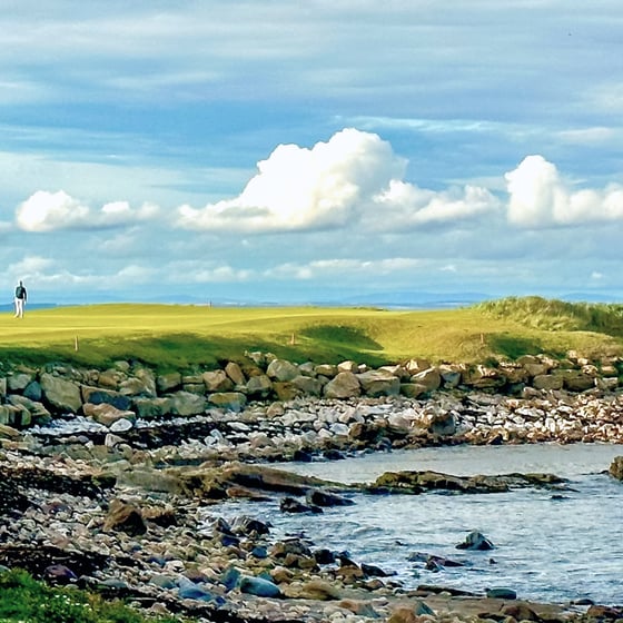 Student with phone in front of St Andrews landmarks